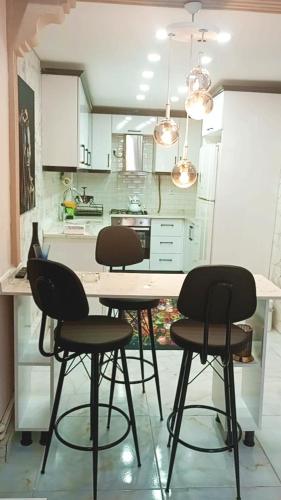 a kitchen with four chairs and a table in a room at Kiralık daire in Yalova