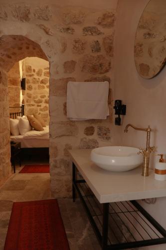 a bathroom with a sink and a bed in a room at Zabel Hotel in Mardin