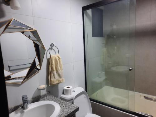 a bathroom with a shower and a sink and a toilet at Ámbar B3-P15-TC in Cochabamba