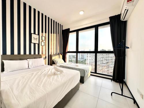 a bedroom with two beds and a large window at Georgetown Classic Collection 3BR-10PAX in George Town