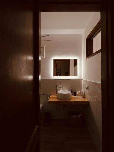a bathroom with a sink and a mirror at Tyche House Castelmola in Castelmola