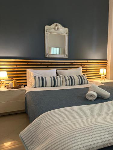 two beds in a bedroom with a mirror on the wall at CactusHome in Epanomi