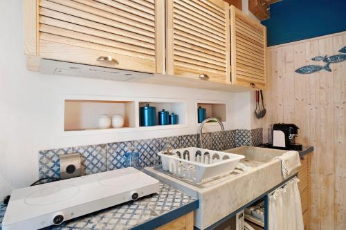 a kitchen with a sink and a counter top at La casa incantata in San Bartolomeo al Mare