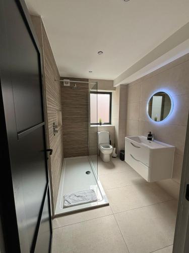 a bathroom with a shower and a toilet and a sink at Pilgrim House by Phoenix Collection in Liverpool