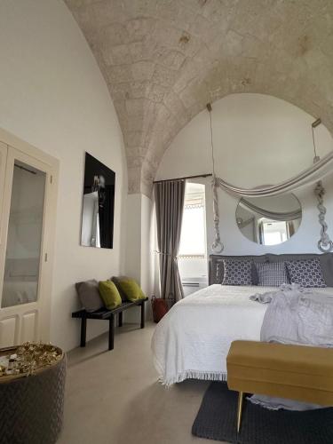 a bedroom with a large bed with a large mirror at Suite Sami Charming Home in Ostuni
