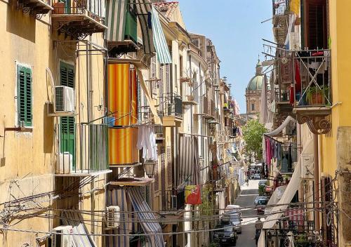 an alley with buildings and cars on a street at Solemar Sicilia - Casa Enrica in Palermo