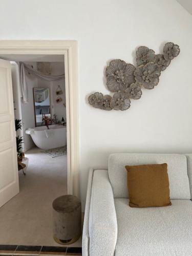 a white living room with a couch and a bathroom at Suite Sami Charming Home in Ostuni