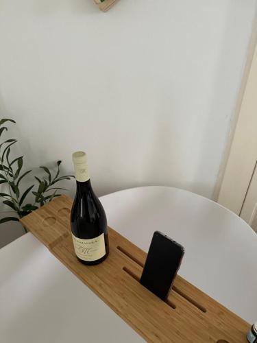 a bottle of wine sitting on a wooden tray at Suite Sami Charming Home in Ostuni