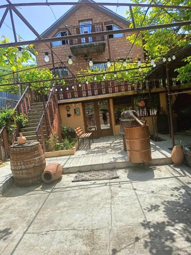 a courtyard of a house with a staircase and a building at Avtos's Winery in Tbilisi City