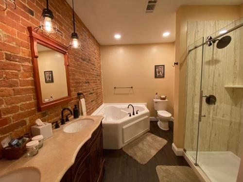 a bathroom with a sink and a tub and a toilet at The Swope Manor Bed & Breakfast in Gettysburg