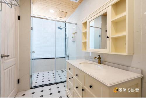 a bathroom with a sink and a glass shower at Good Times BnB in Chishang