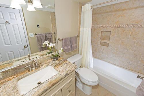 a bathroom with a sink and a toilet and a tub at 3 Bedroom 2 Bath Sandpiper Condo with Ocean Views in Pawleys Island