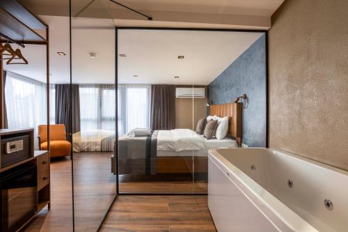 a bedroom with a bed and a tub in a room at Marlon Hotel in Istanbul