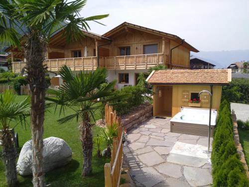 a house with a hot tub in a yard at Chalet Schaller in Tesimo