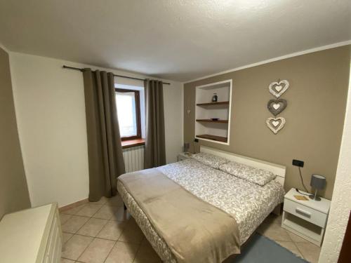 Ένα ή περισσότερα κρεβάτια σε δωμάτιο στο CASA VACANZE A LA SALLE