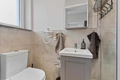 a bathroom with a white toilet and a sink at 24-7 Living - Modern Apartments in Waltrop with Top Connection in Waltrop
