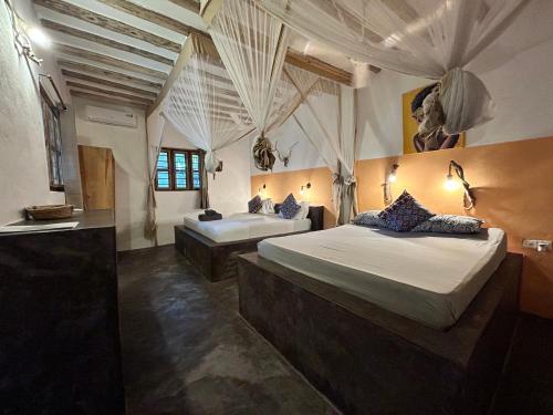 a bedroom with two beds in a room at Bahari Beach Bungalows in Jambiani