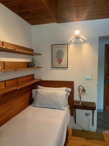 a bedroom with a bed and a lamp on a table at Villa 225 in Bracciano