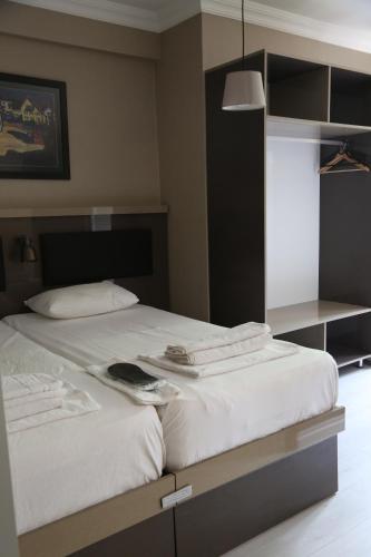 a bedroom with a large bed with white sheets at Maidos suites in Eceabat