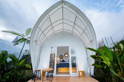 an arched entry way to a bedroom in a house at The Dewi Kintamani Luxury Glamping and Natural Hotspring in Kintamani