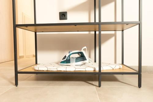 a glass shelf with a telephone on top at Lorien City Center Apartments in Ioannina
