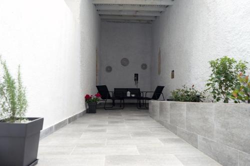a patio with a table and potted plants at Lorien City Center Apartments in Ioannina