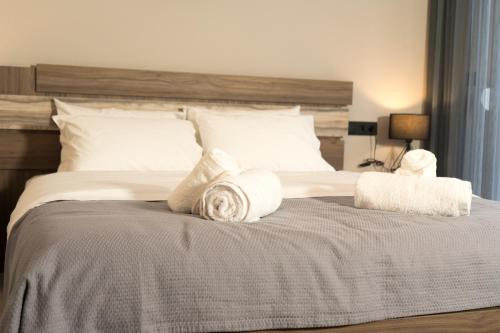 a bedroom with a large bed with towels on it at Lorien City Center Apartments in Ioannina