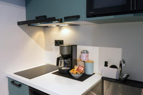 a kitchen with a coffee maker on a counter at Lorien City Center Apartments in Ioannina