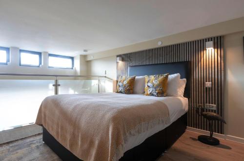 a bedroom with a large bed and a window at Palm Tree House - Birds of Feather in Orpington