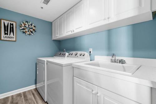 a white laundry room with a washer and a sink at Beachfront Oasis at Litchfield By the Sea: 3 Bdrm in Pawleys Island