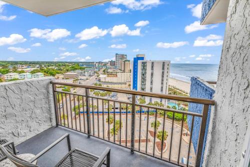 a balcony with chairs and a view of the beach at Ocean View 1BR Condo in Myrtle Beach