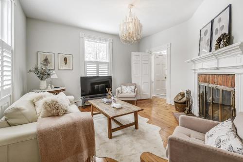 a living room with a couch and a fireplace at Beautiful Historic Luxury Getaway in Niagara-on-the-Lake