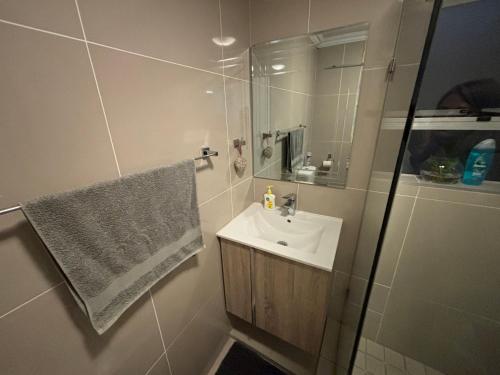 a bathroom with a sink and a shower at Tyger Valley Villa in Durbanville