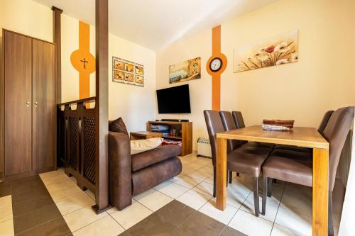 a living room with a table and a dining room at Appartamento Alexander in Tignale