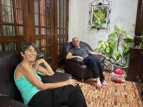 a man and a woman sitting in chairs in a living room at Leisure home in Colombo