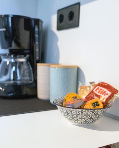 a bowl of food sitting on a counter next to a coffee maker at Lorien City Center Apartments in Ioannina
