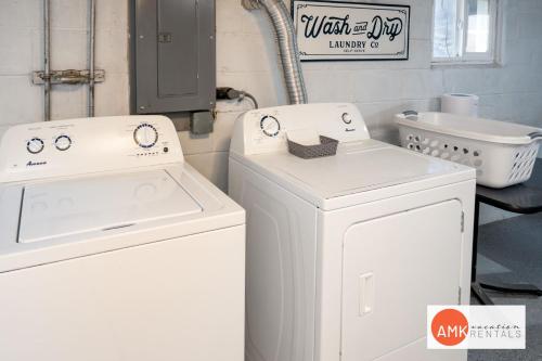a laundry room with two white washes and a sink at Holland Hideaway in Holland