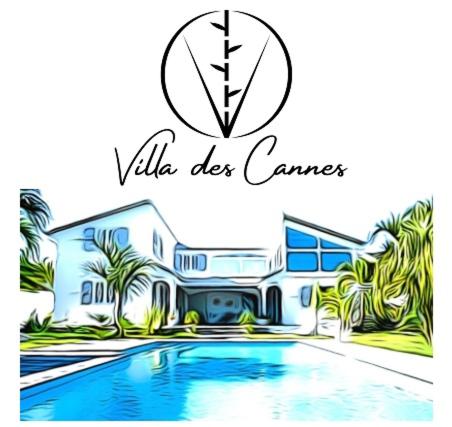 a house with a swimming pool in front of it at La Villa des Cannes in Sainte-Marie