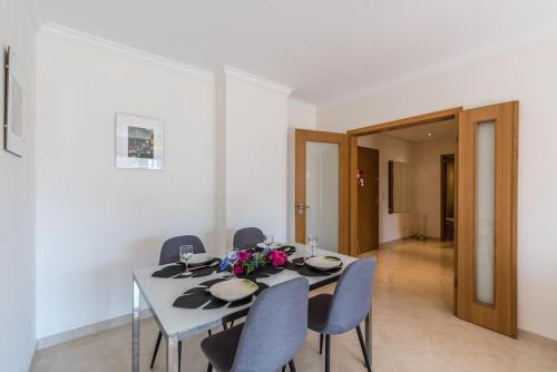 a dining room with a table and some chairs at Marina Apartment close to beach & city in Portimão