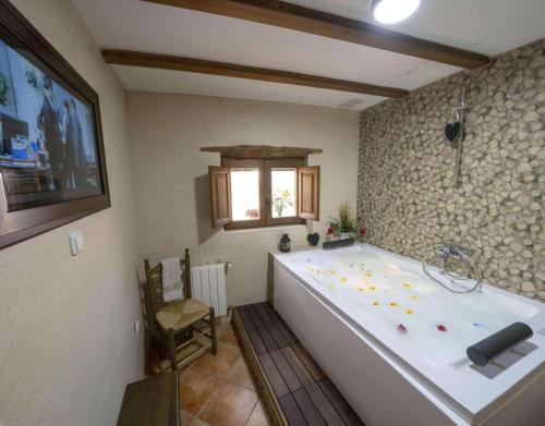 a large bath tub in a bathroom with a window at Casa Rural Padre Ramon in Laroya