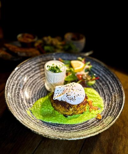 a plate of food on a wooden table at Quite Simply French in Lancaster