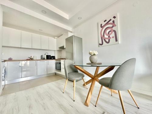 a kitchen with a dining table and two chairs at Double Studio B606 StayInn by Cosmopolis in Creţuleasca