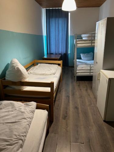 a room with two beds and a bunk bed at Pension Nürnberg in Nürnberg
