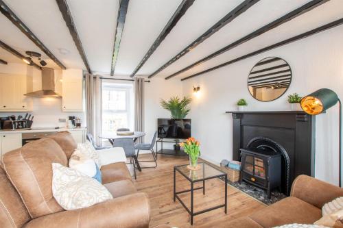 a living room with a couch and a fireplace at Northern Hideaways, Castle Hill View in Bellingham