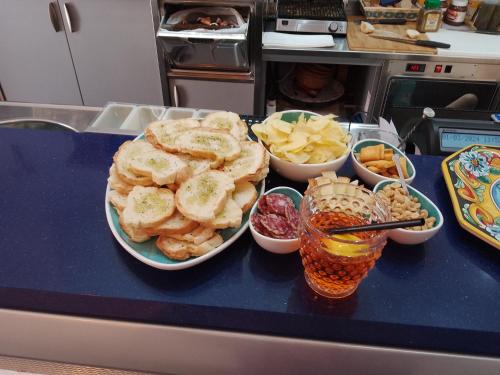 a counter top with bowls of food and bowls of snacks at Casamia in Portopalo