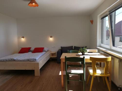 a living room with a bed and a table and a couch at Apartma pr´ Štengarju in Bohinjska Bela