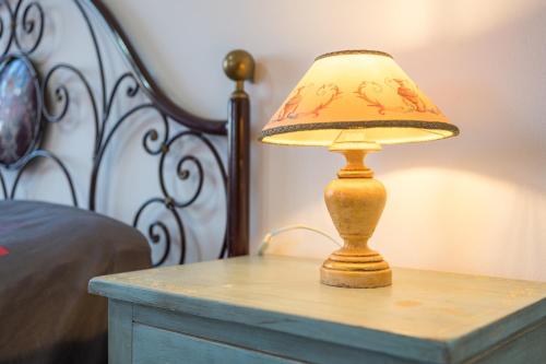a lamp on a table next to a bed at Art Rooms in Arezzo