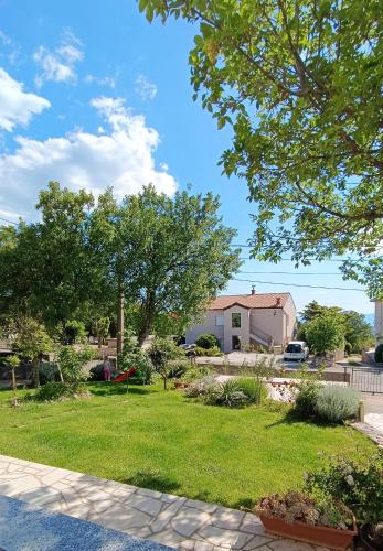 a house with a yard with grass and trees at Apartment Olivia in Šmrika
