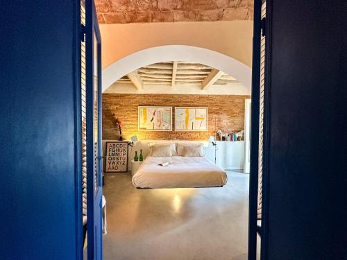 a bedroom with a large bed in a room at Residenza dell'Orto - Residenze Tonnina Group in Guardistallo