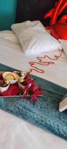 a tray of food sitting on top of a bed at Mosswood Bed & Breakfast in Graskop